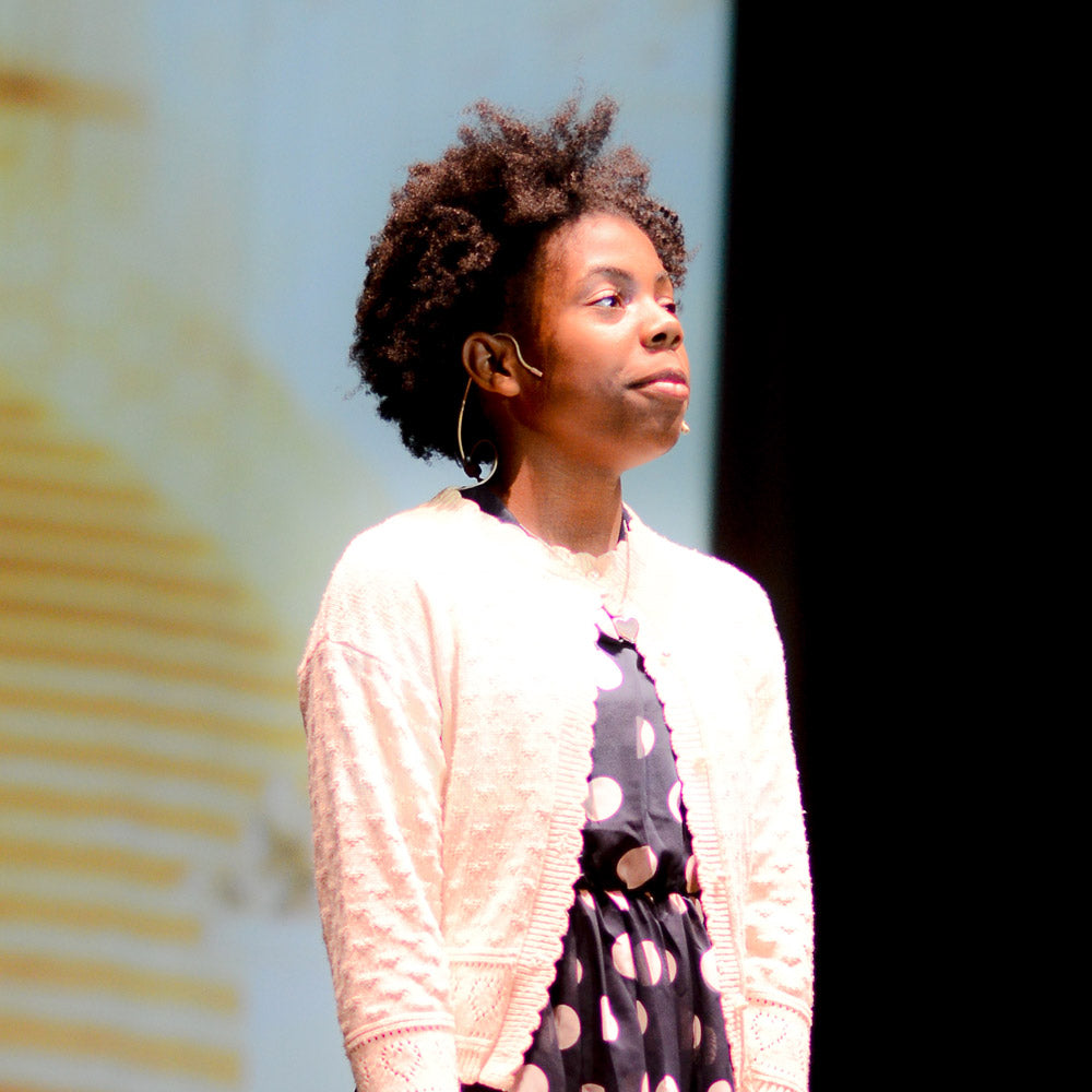 Annie the Musical actress in front of scenic projection backdrop