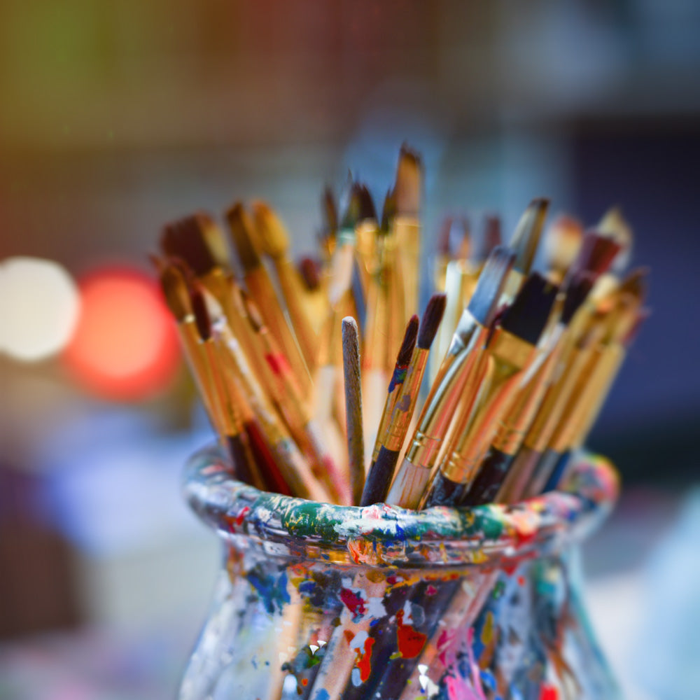A jar of used paintbrushes to pair with a Chuck Close quote about creativity